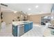 Open kitchen with blue cabinets and an island has a convenient dishwasher for easy cleanup at 6450 Trade Ct, Spring Hill, FL 34606