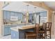 The open kitchen features blue cabinets, modern appliances, and a breakfast bar with seating at 6450 Trade Ct, Spring Hill, FL 34606