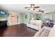 Enjoy the spacious living room featuring comfortable seating, ceiling fans, and wood-look floors at 6450 Trade Ct, Spring Hill, FL 34606