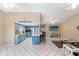 Open living room and kitchen provides a spacious layout for dining and gathering at 6450 Trade Ct, Spring Hill, FL 34606