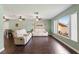 Relax in the living room with a large window, ceiling fan, and wood-look flooring at 6450 Trade Ct, Spring Hill, FL 34606
