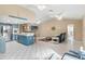 Open living room and kitchen has abundant sunlight, creating a warm and inviting atmosphere at 6450 Trade Ct, Spring Hill, FL 34606
