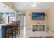 Inviting living room with bar seating and a view of the open kitchen area and front door at 6450 Trade Ct, Spring Hill, FL 34606