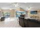 Spacious living room and kitchen area with sliding doors to outdoor living and entertainment spaces at 6450 Trade Ct, Spring Hill, FL 34606