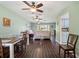 Open-concept space integrating a living room, dining area, and kitchen with wood-look floors at 6450 Trade Ct, Spring Hill, FL 34606