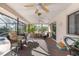 Covered patio with ceiling fans, wicker furniture, and a view of the pool and backyard at 6450 Trade Ct, Spring Hill, FL 34606