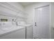 Bright laundry room with washer, dryer, and extra storage at 7499 Heather Walk, Weeki Wachee, FL 34613