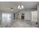 Bright living room featuring tile floors and sliding glass doors leading to a sunroom at 7499 Heather Walk, Weeki Wachee, FL 34613
