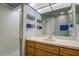 Bathroom with a shower and wood vanity at 7499 Heather Walk, Weeki Wachee, FL 34613
