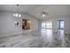 Open living area with tile floors and views of kitchen and sunroom at 7499 Heather Walk, Weeki Wachee, FL 34613