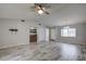 Spacious living room with tile flooring, a ceiling fan, and an open floor plan at 7499 Heather Walk, Weeki Wachee, FL 34613