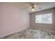 Bedroom with ceiling fan and window with blinds at 7499 Heather Walk, Weeki Wachee, FL 34613