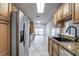 Modern kitchen with stainless steel appliances and tile flooring at 7499 Heather Walk, Weeki Wachee, FL 34613