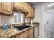 Kitchen features granite countertops and wood cabinets at 7499 Heather Walk, Weeki Wachee, FL 34613