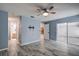 Main bedroom with tile floors, ceiling fan, and access to bathroom and sunroom at 7499 Heather Walk, Weeki Wachee, FL 34613