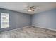 Bright bedroom featuring a window with blinds and tile floors at 7499 Heather Walk, Weeki Wachee, FL 34613