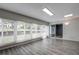 Sunroom with wood-look flooring and wall-to-wall windows with blinds at 7499 Heather Walk, Weeki Wachee, FL 34613