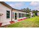 Private backyard with a spacious sunroom and well-maintained lawn at 7499 Heather Walk, Weeki Wachee, FL 34613