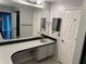 Bathroom with vanity, sink, and a large mirror at 8353 Forest Oaks Blvd, Spring Hill, FL 34606