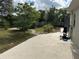 Landscaped backyard with concrete patio and shed at 8353 Forest Oaks Blvd, Spring Hill, FL 34606