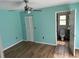 Light teal bedroom with wood-look floors and en-suite bathroom at 8353 Forest Oaks Blvd, Spring Hill, FL 34606