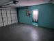 Attached garage with light teal walls and an automatic door at 8353 Forest Oaks Blvd, Spring Hill, FL 34606