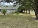 House with spacious front yard and mature trees at 8353 Forest Oaks Blvd, Spring Hill, FL 34606