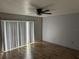 Bright living room with wood-look floors and sliding glass doors at 8353 Forest Oaks Blvd, Spring Hill, FL 34606