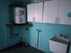 Laundry room with white cabinets and a utility sink at 8353 Forest Oaks Blvd, Spring Hill, FL 34606