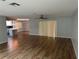 Open concept living area with hardwood floors and kitchen island at 8353 Forest Oaks Blvd, Spring Hill, FL 34606