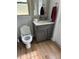 Clean bathroom with granite countertop and gray vanity at 8353 Forest Oaks Blvd, Spring Hill, FL 34606