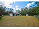 Home's rear view, showing the house, yard, and shed at 9043 Glenarm Way, Weeki Wachee, FL 34613