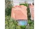 A high angle view of a home showcasing an enclosed pool and hot tub, as well as an orange tile roof at 10441 Garda Dr, Trinity, FL 34655