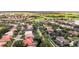 A gorgeous aerial view of a community with lush greenery and lakes surrounding the homes at 10441 Garda Dr, Trinity, FL 34655