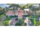 Beautiful clubhouse with red tiled roof surrounded by landscaped grounds and palm trees at 10441 Garda Dr, Trinity, FL 34655