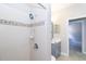 Clean bathroom with a shower/tub combo, vanity, and view of bedroom at 10441 Garda Dr, Trinity, FL 34655