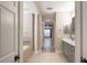 Bathroom featuring double sinks, a bathtub, and wood-look floors running into an adjacent room at 10441 Garda Dr, Trinity, FL 34655