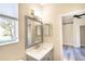 Bathroom with single vanity, large mirror, and natural light at 10441 Garda Dr, Trinity, FL 34655