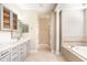 Bright bathroom with double sink vanity, soaking tub and walk-in shower at 10441 Garda Dr, Trinity, FL 34655