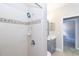 Bathroom featuring single vanity and tiled shower at 10441 Garda Dr, Trinity, FL 34655