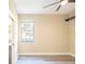Bright bedroom featuring hardwood floors, a ceiling fan, and a window offering natural light at 10441 Garda Dr, Trinity, FL 34655