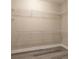 Walk-in closet with wire shelving and base trim, perfect for organizing clothes and accessories at 10441 Garda Dr, Trinity, FL 34655