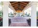 Beautiful building entrance featuring a portico with classic columns and double glass doors at 10441 Garda Dr, Trinity, FL 34655