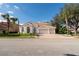 Traditional home with a 3-car garage, arched windows, tile roof, manicured lawn, and brick driveway at 10441 Garda Dr, Trinity, FL 34655