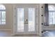 Elegant double doors with decorative glass inserts, leading to the home's interior at 10441 Garda Dr, Trinity, FL 34655