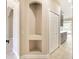Hallway with tiled floors, an arched alcove, and leading to the kitchen at 10441 Garda Dr, Trinity, FL 34655