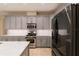Modern kitchen features stainless steel appliances, grey cabinetry, and marble countertops at 10441 Garda Dr, Trinity, FL 34655