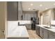 Bright kitchen with stainless steel appliances, marble countertops, and grey cabinetry at 10441 Garda Dr, Trinity, FL 34655