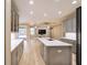 Open kitchen design with gray cabinetry, marble countertops, and a seamless view to the living area at 10441 Garda Dr, Trinity, FL 34655