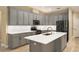 Modern kitchen with gray cabinets, stainless steel appliances, and a marble countertop island at 10441 Garda Dr, Trinity, FL 34655